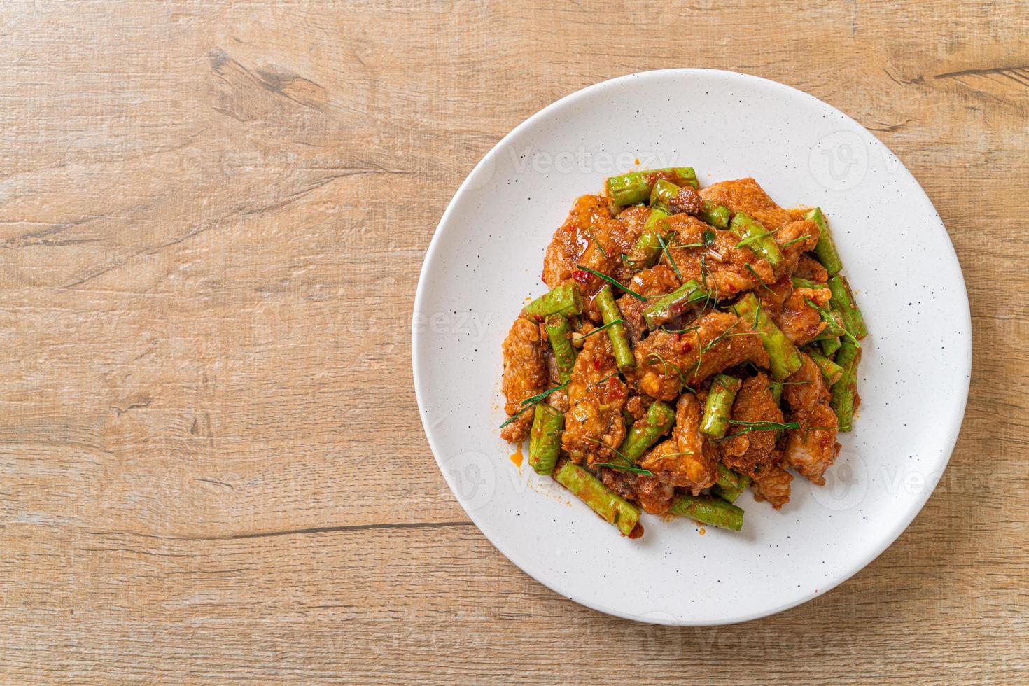 Stir fried pork and red curry paste with sting bean photo