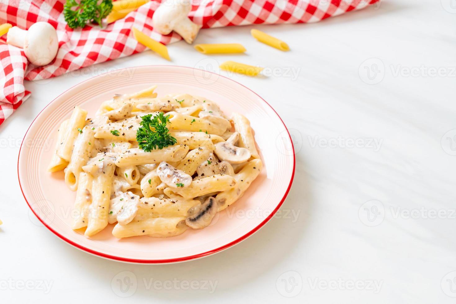 Penne pasta carbonara cream sauce with mushroom - Italian food style photo