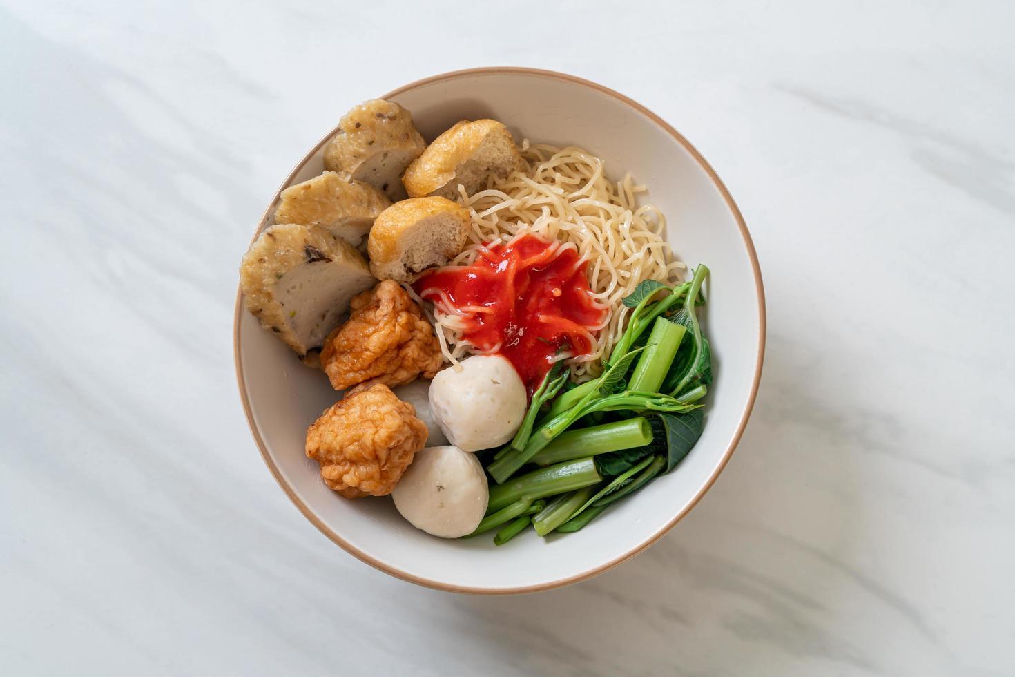 Egg noodles with fish balls and shrimp balls in pink sauce, Yen Ta Four or Yen Ta Fo - Asian food style photo