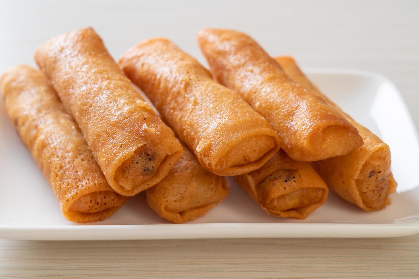 Deep-fried spring roll with sauce on white plate photo
