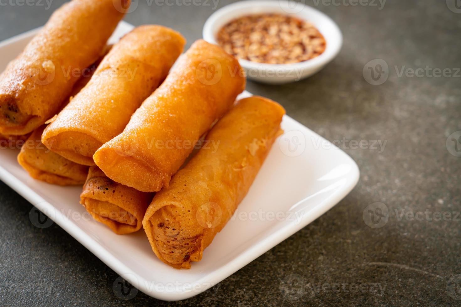 Deep-fried spring roll with sauce on white plate photo