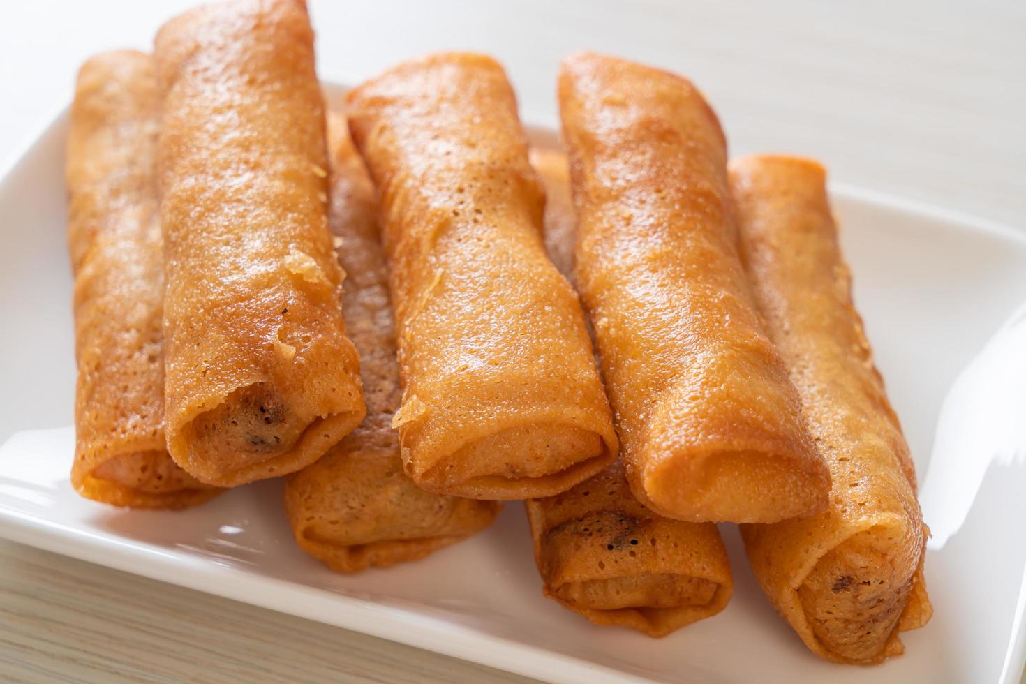 Deep-fried spring roll with sauce on white plate photo