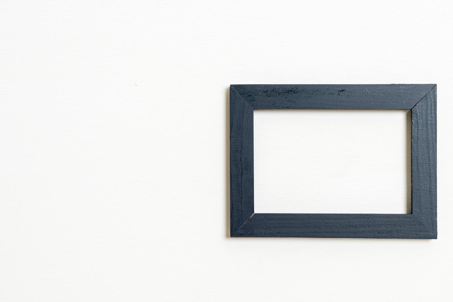 Empty picture frame on white wall background with copy space photo