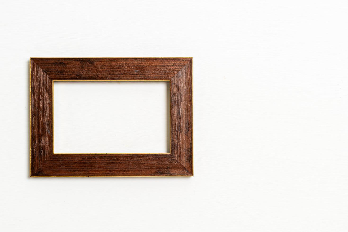 Empty picture frame on white wall background with copy space photo