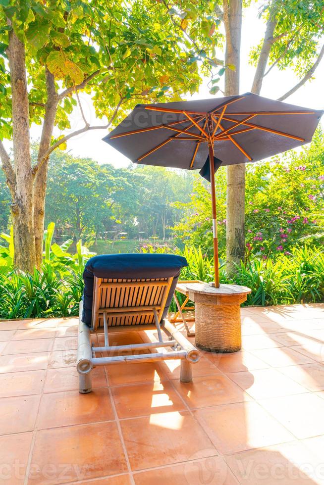 Umbrella and pool bed around swimming pool with river view photo