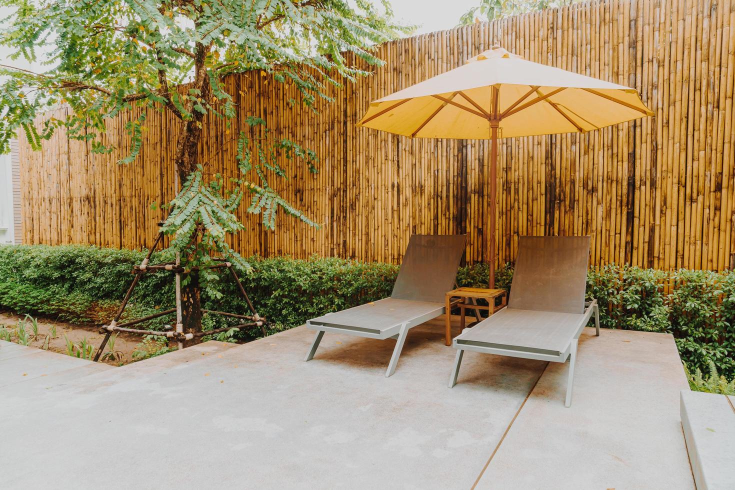 Umbrella and pool bed decoration around swimming pool in hotel resort photo