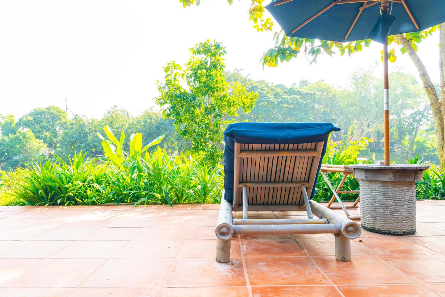 Umbrella and pool bed decoration around swimming pool in hotel resort photo