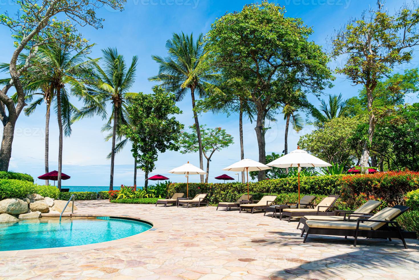 Bed pool around swimming pool in hotel resort - holiday and vacation concept photo