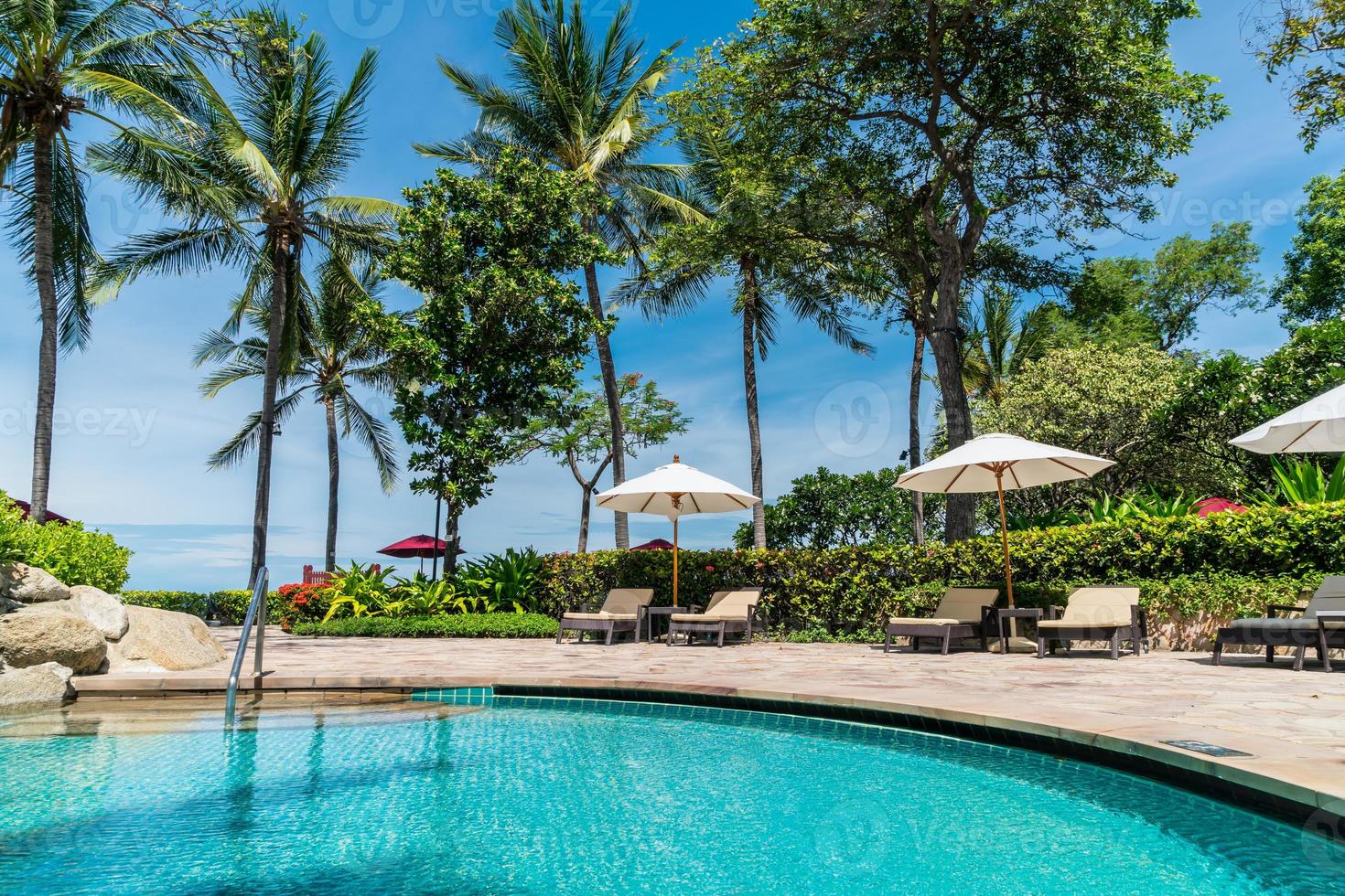 Bed pool around swimming pool in hotel resort - holiday and vacation concept photo