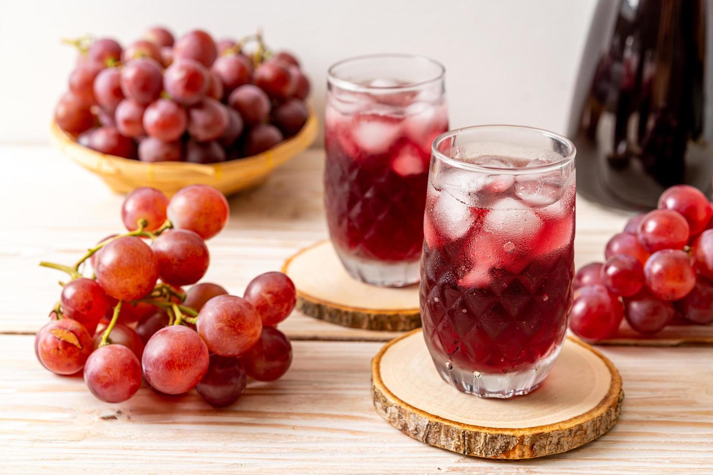 Fresh grape juice on wood background photo