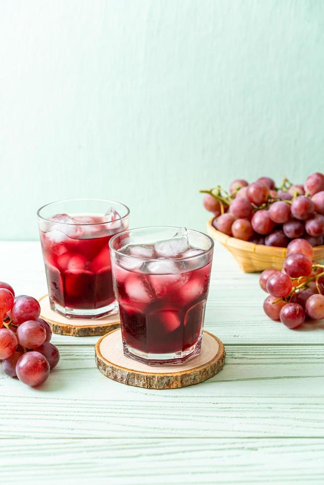 Fresh grape juice on wood background photo