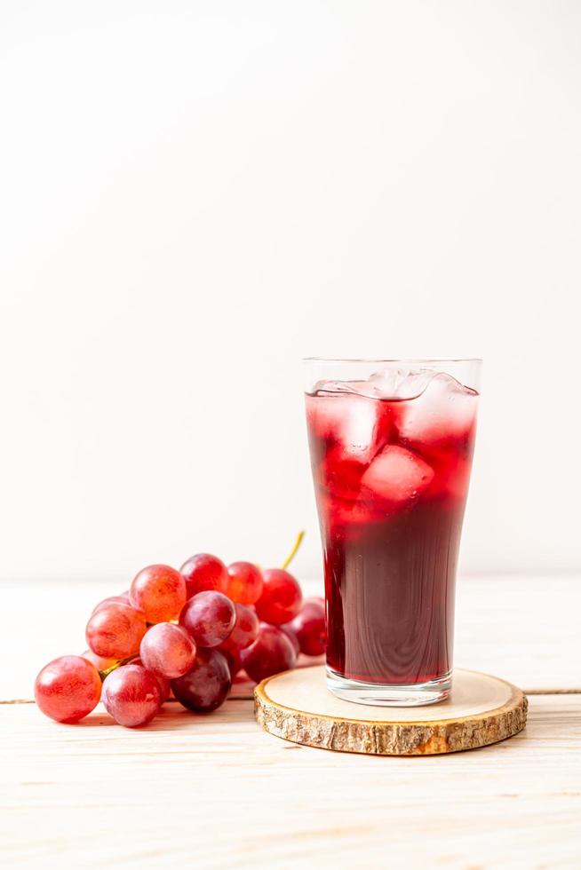 Fresh grape juice on wood background photo