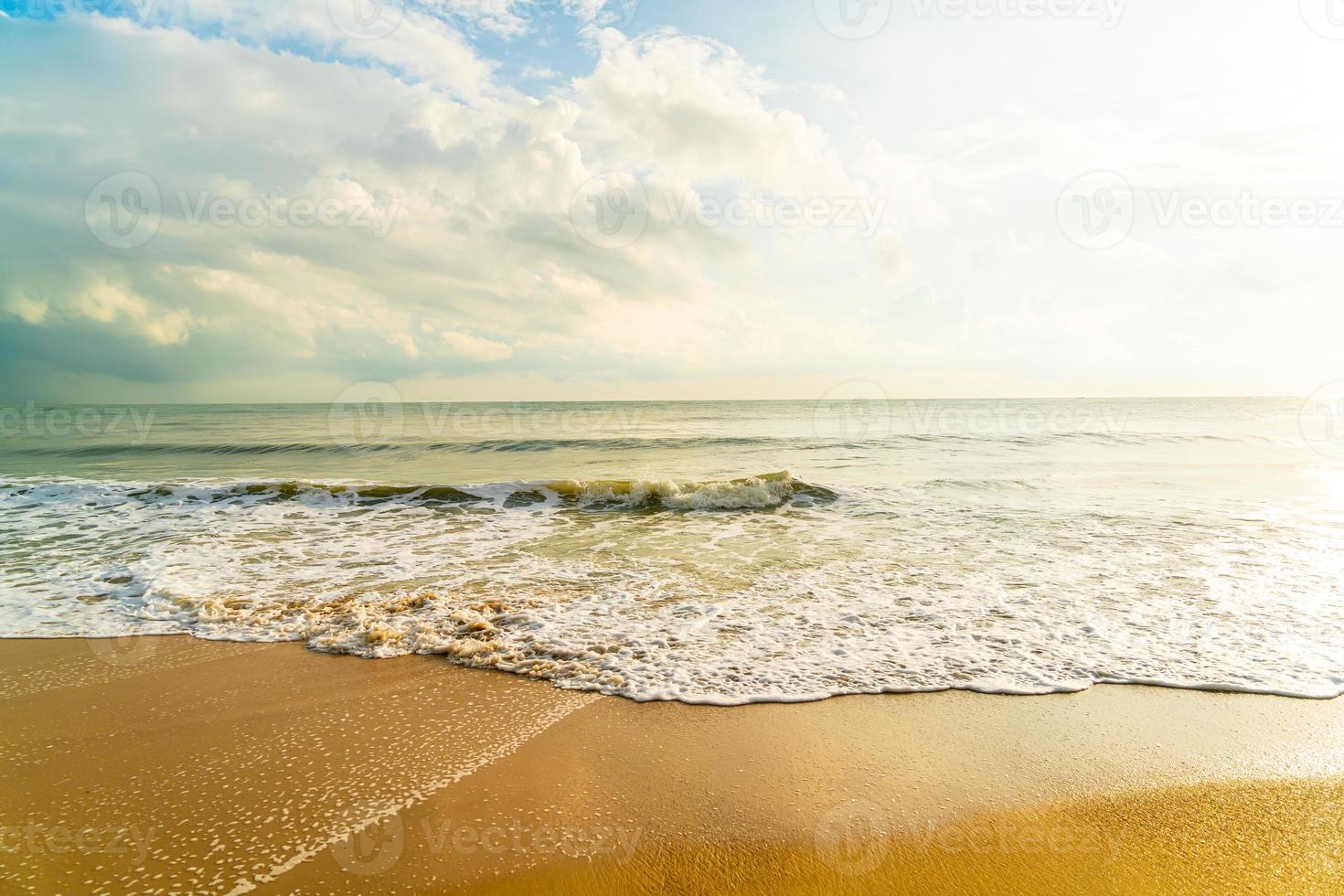 Beautiful and empty beach sea at sunrise or sunset time photo