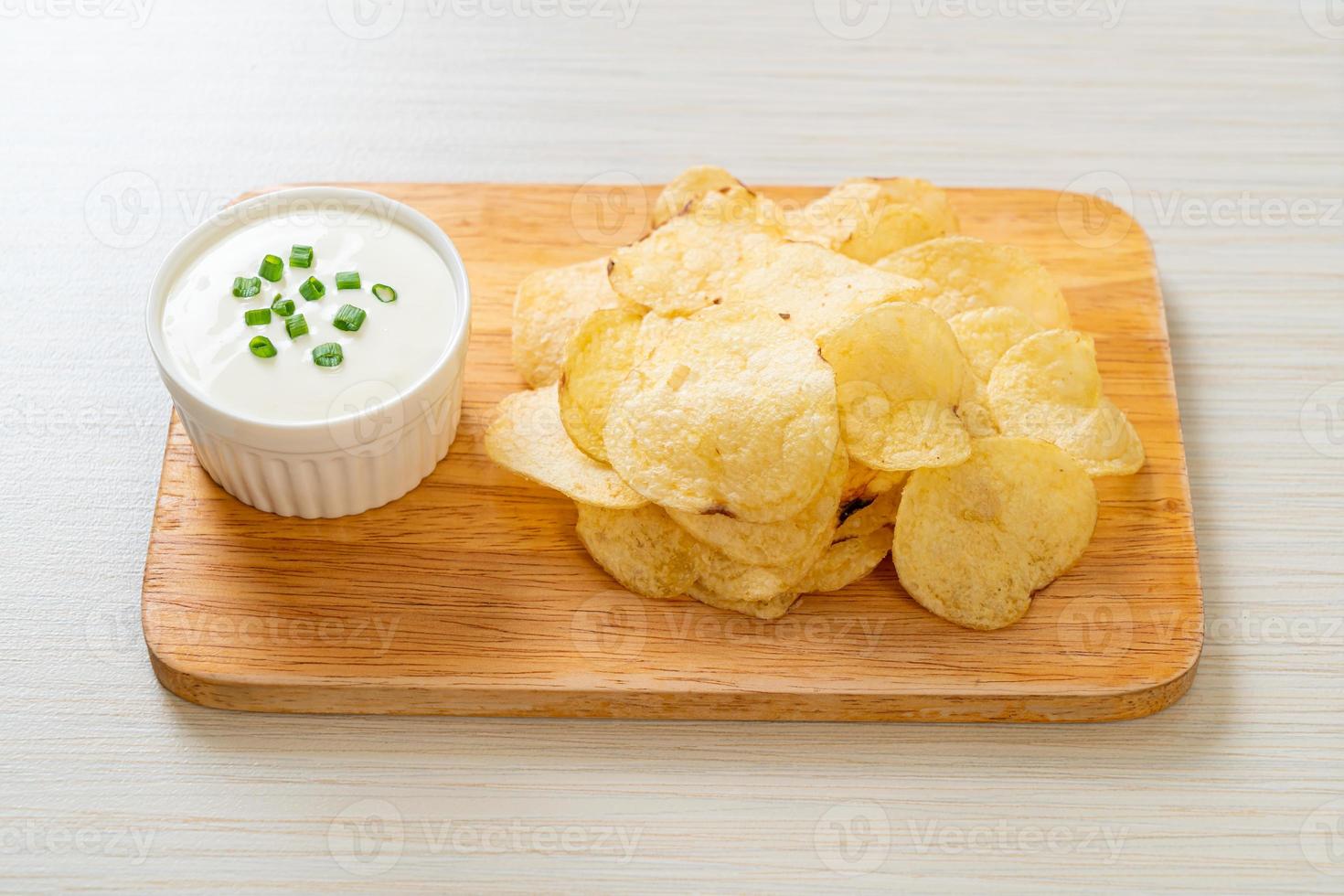 Potato chips with sour cream dipping sauce photo