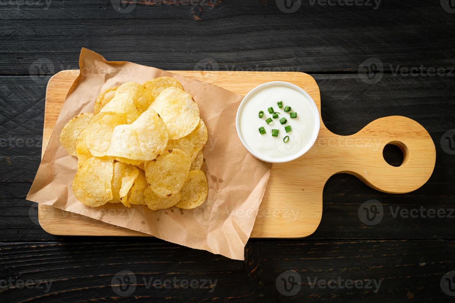 Potato chips with sour cream dipping sauce photo