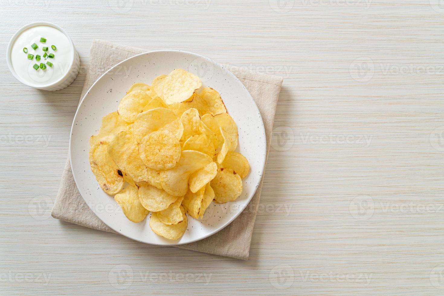 Potato chips with sour cream dipping sauce photo