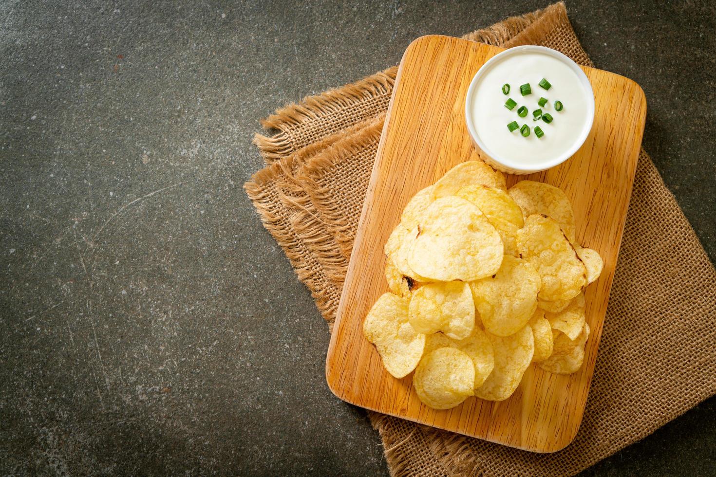 Potato chips with sour cream dipping sauce photo