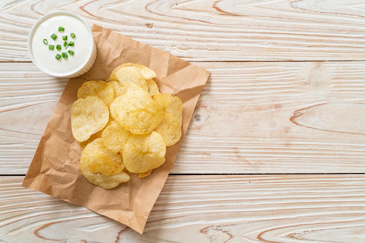 Potato chips with sour cream dipping sauce photo