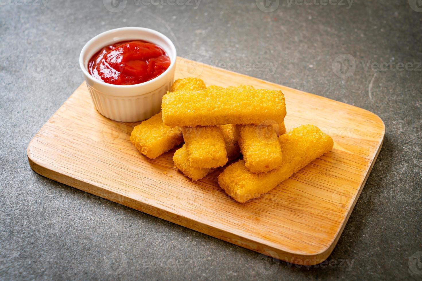 Crispy fried fish fingers with ketchup photo