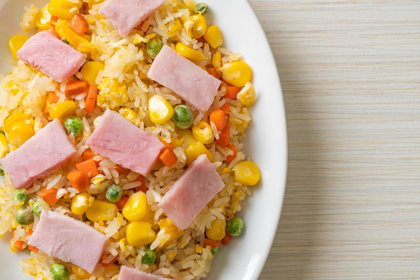 Homemade fried rice with ham and mixed vegetable of carrot, and green bean peas photo