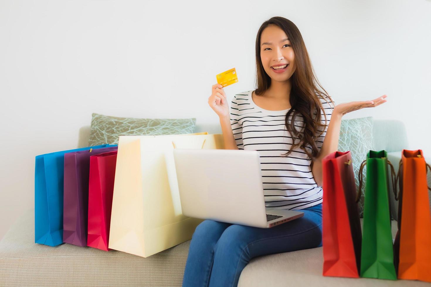 Portrait beautiful young asian women with credit card mobile phone or computer for shopping photo