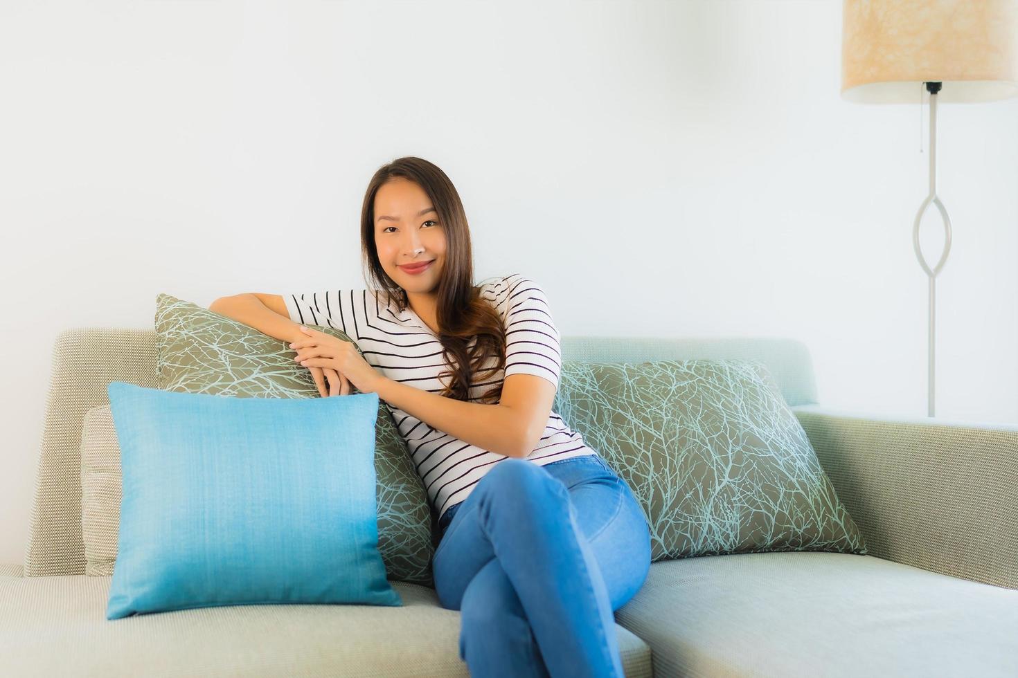 Portrait beautiful young asian woman smile happy on sofa photo
