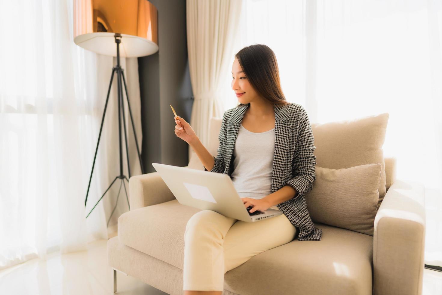 Portrait beautiful young asian women using computer laptop or smart and mobile phone with credit card for online shopping photo
