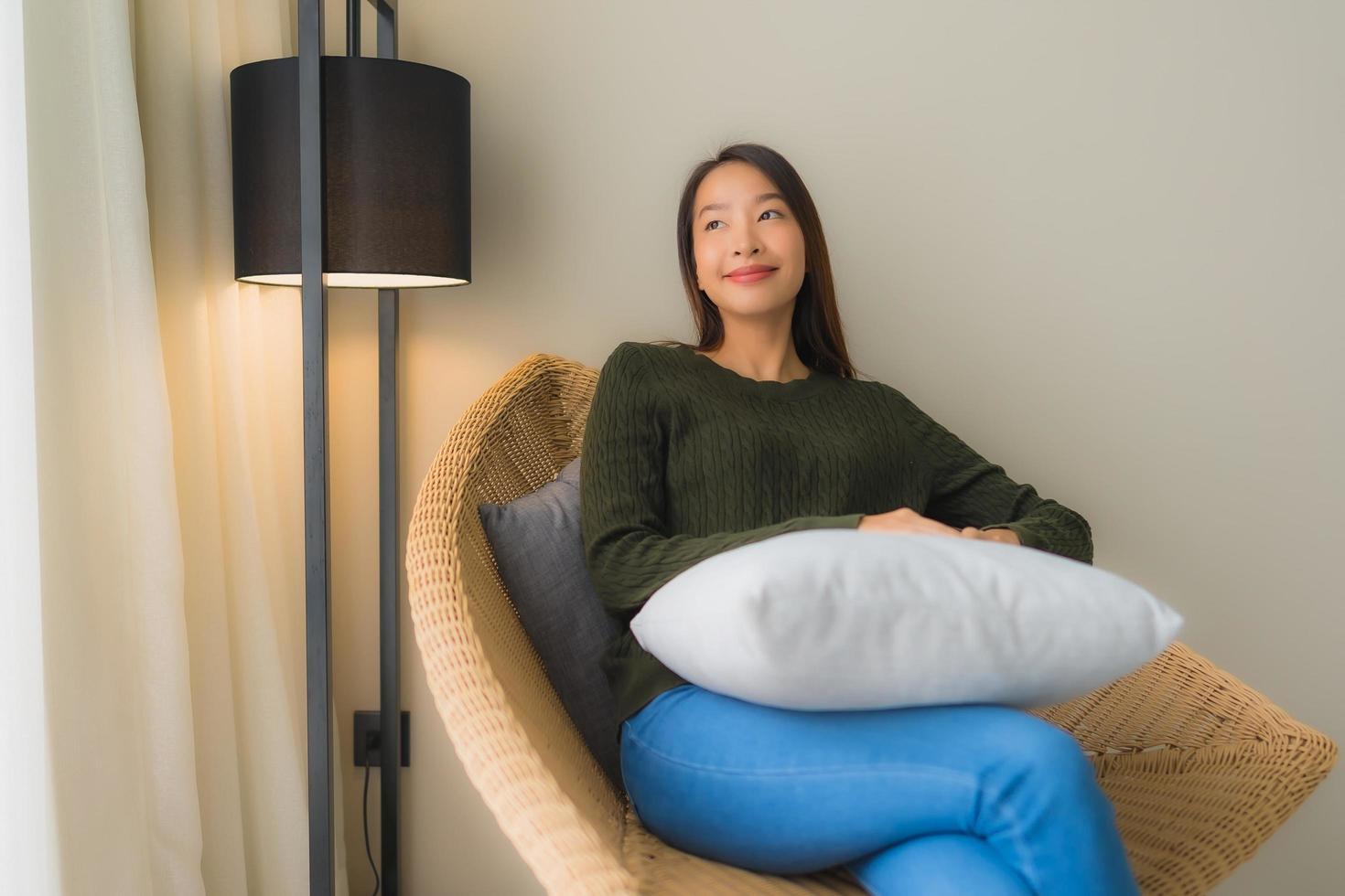 Portrait beautiful young asian women happy smile relax sitting on sofa chair photo