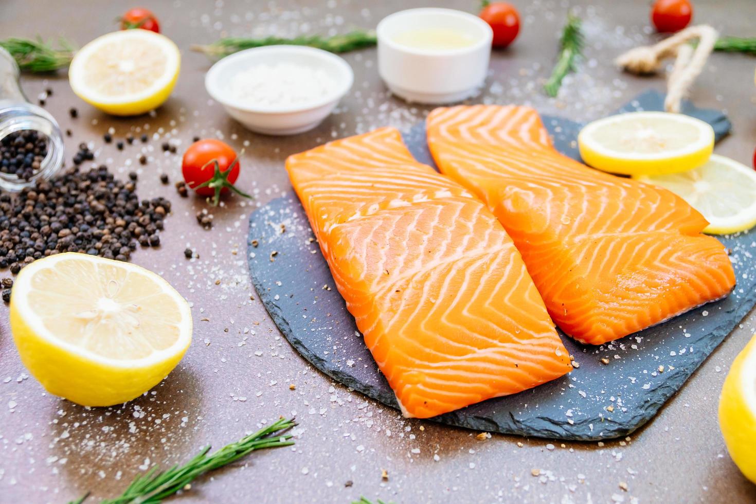 Raw and fresh salmon meat fillet on black stone slate photo