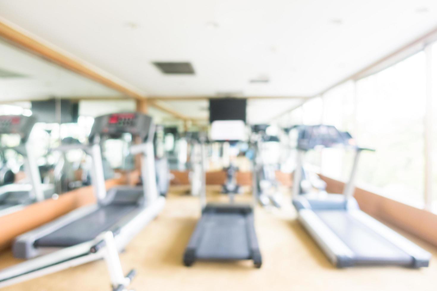 Abstract blur and defocused sport fitness equipment in gym interior photo