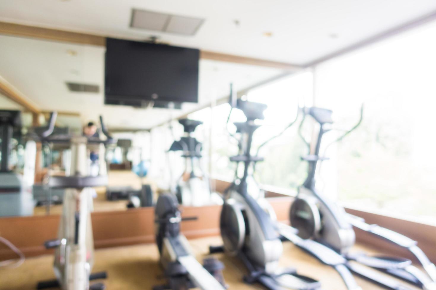 Abstract blur and defocused sport fitness equipment in gym interior photo