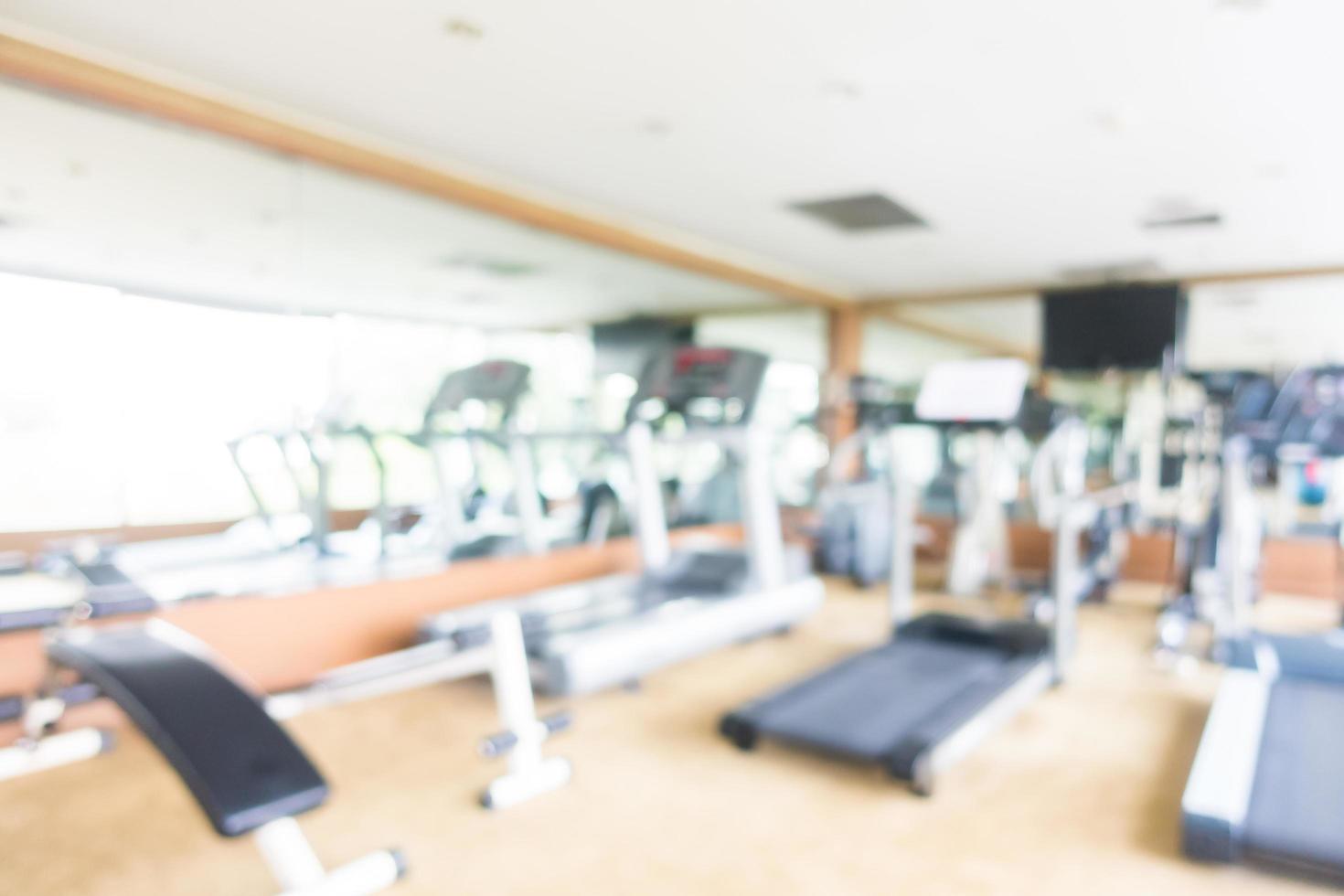 Abstract blur and defocused sport fitness equipment in gym interior photo