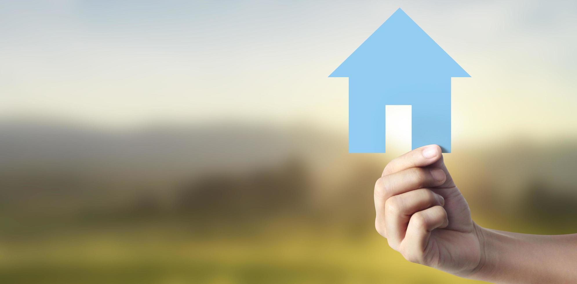 Hands holding  paper house, family home protecting insurance concept photo