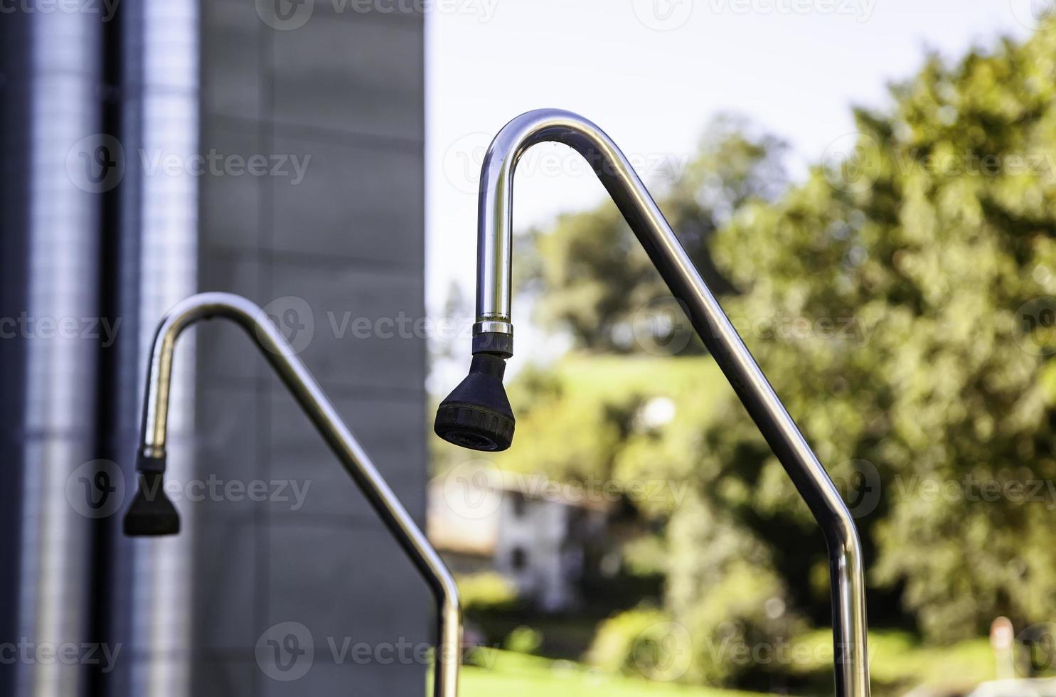 Outdoor showers in a swimming pool photo