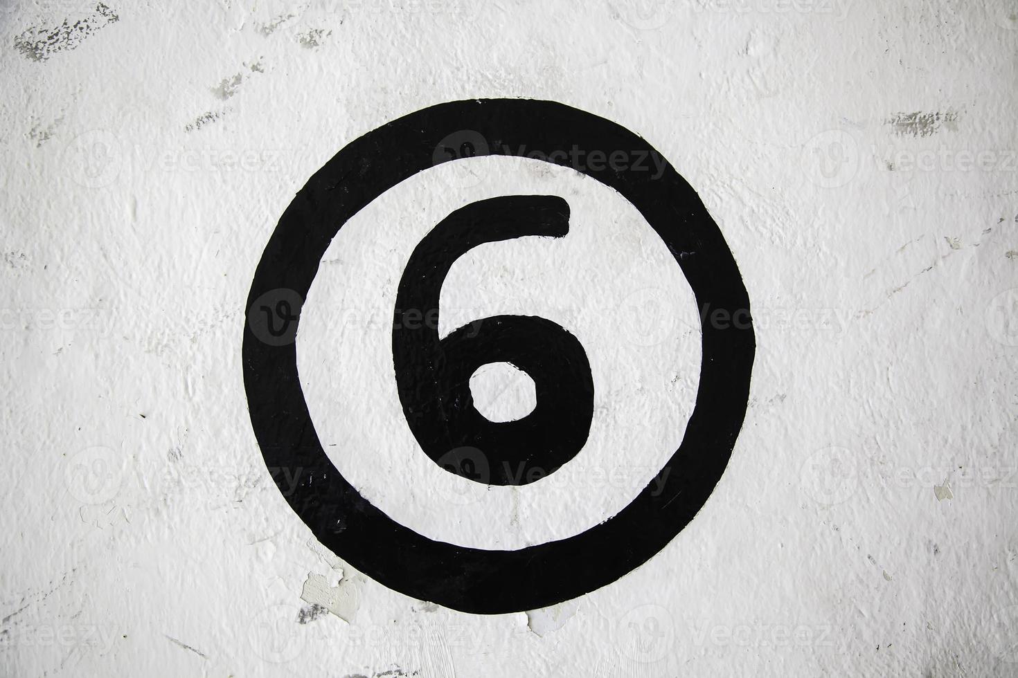 Number six on a white wall photo