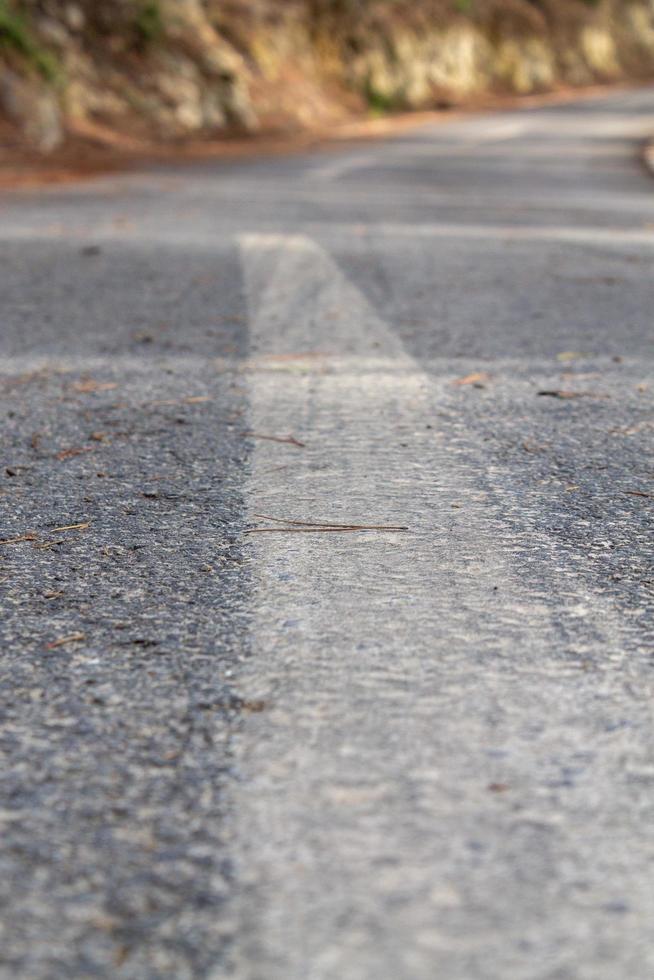 Black asphalt road and white dividing lines photo