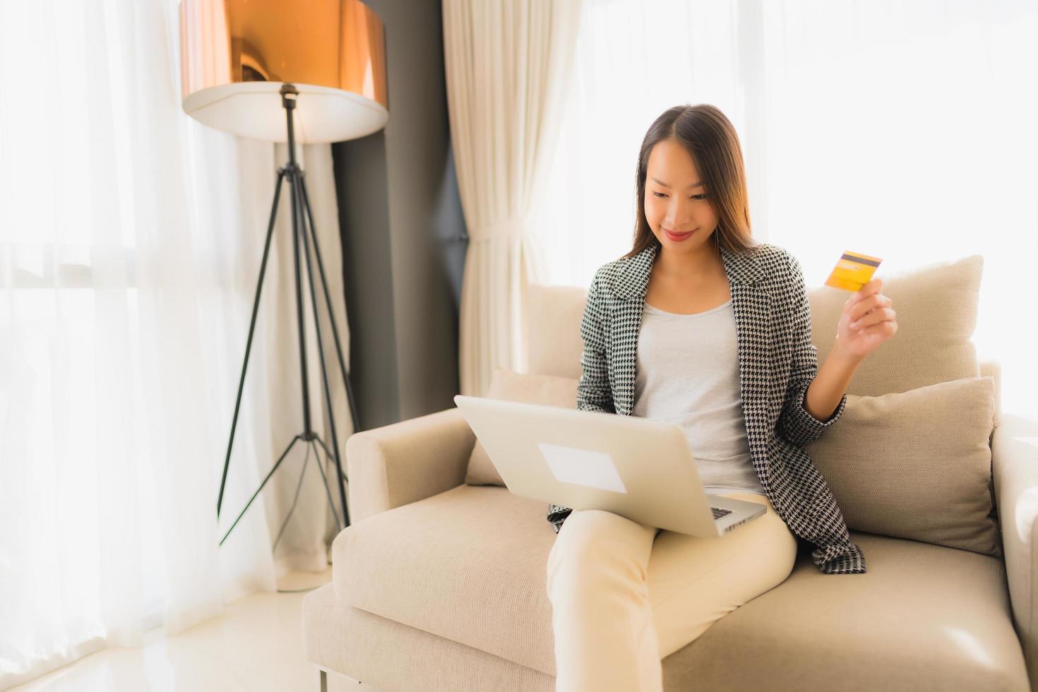 Portrait beautiful young asian women using computer laptop or smart and mobile phone with credit card for online shopping photo