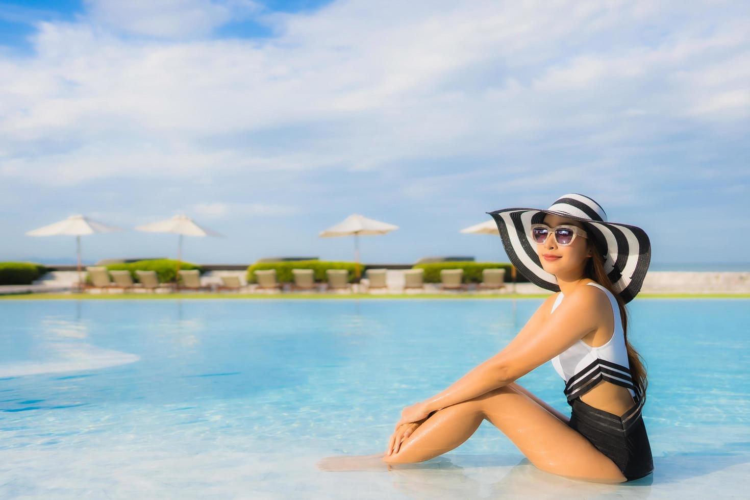 Portrait beautiful young asian women happy smile relax around swimming pool photo