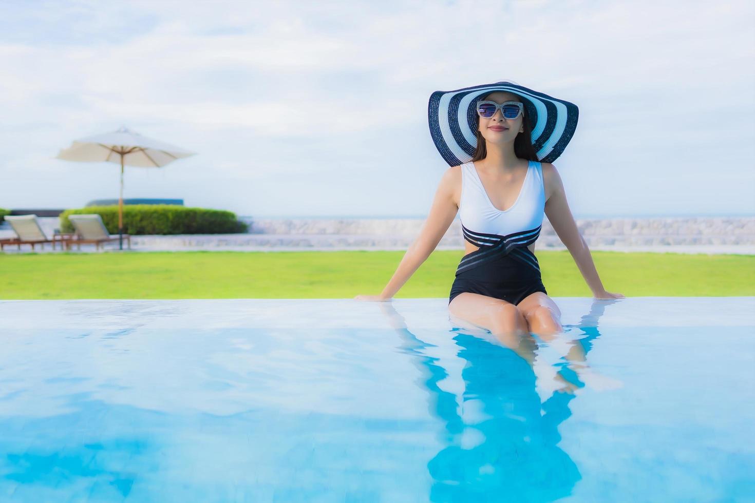 Portrait beautiful young asian women happy smile relax around swimming pool photo