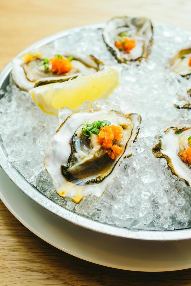 Raw and fresh oyster shell with lemon photo