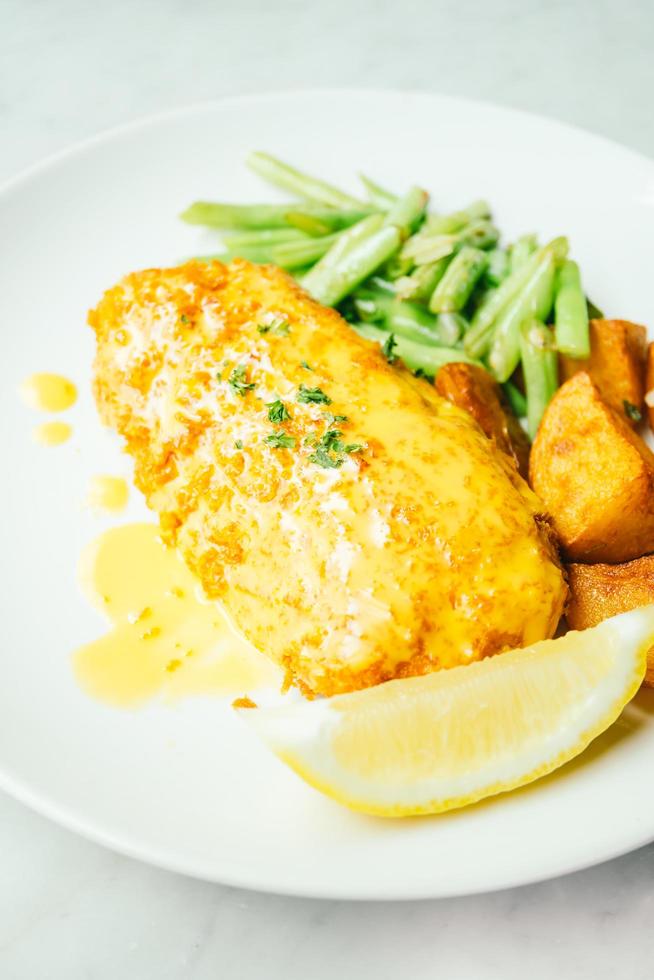 Fried chicken steak with lemon and vegetable photo