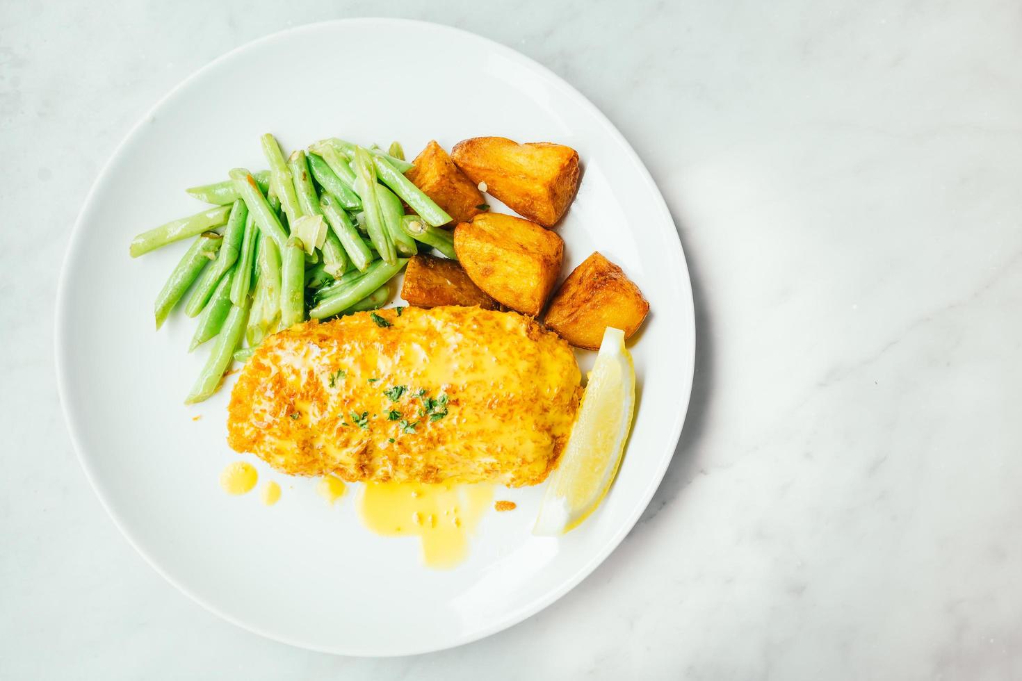 Fried chicken steak with lemon and vegetable photo