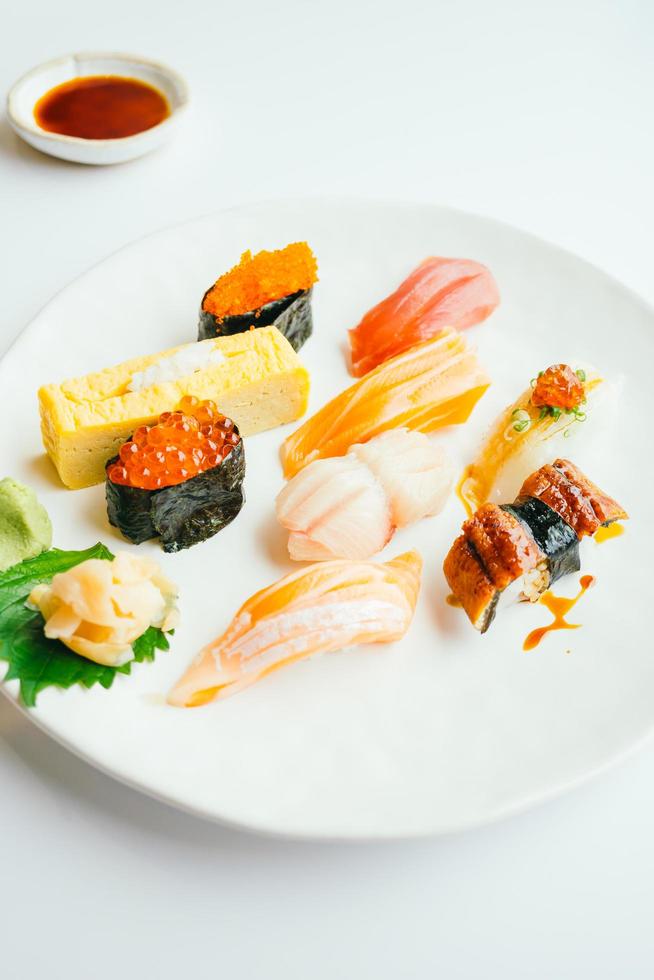 Raw and fresh nigiri sushi set in white plate photo