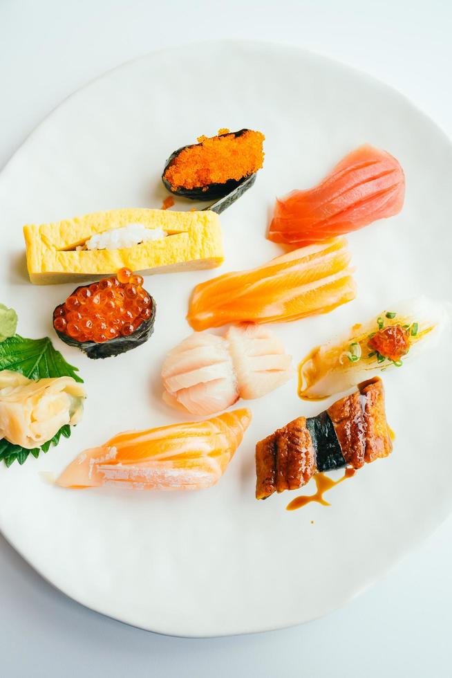 Raw and fresh nigiri sushi set in white plate photo