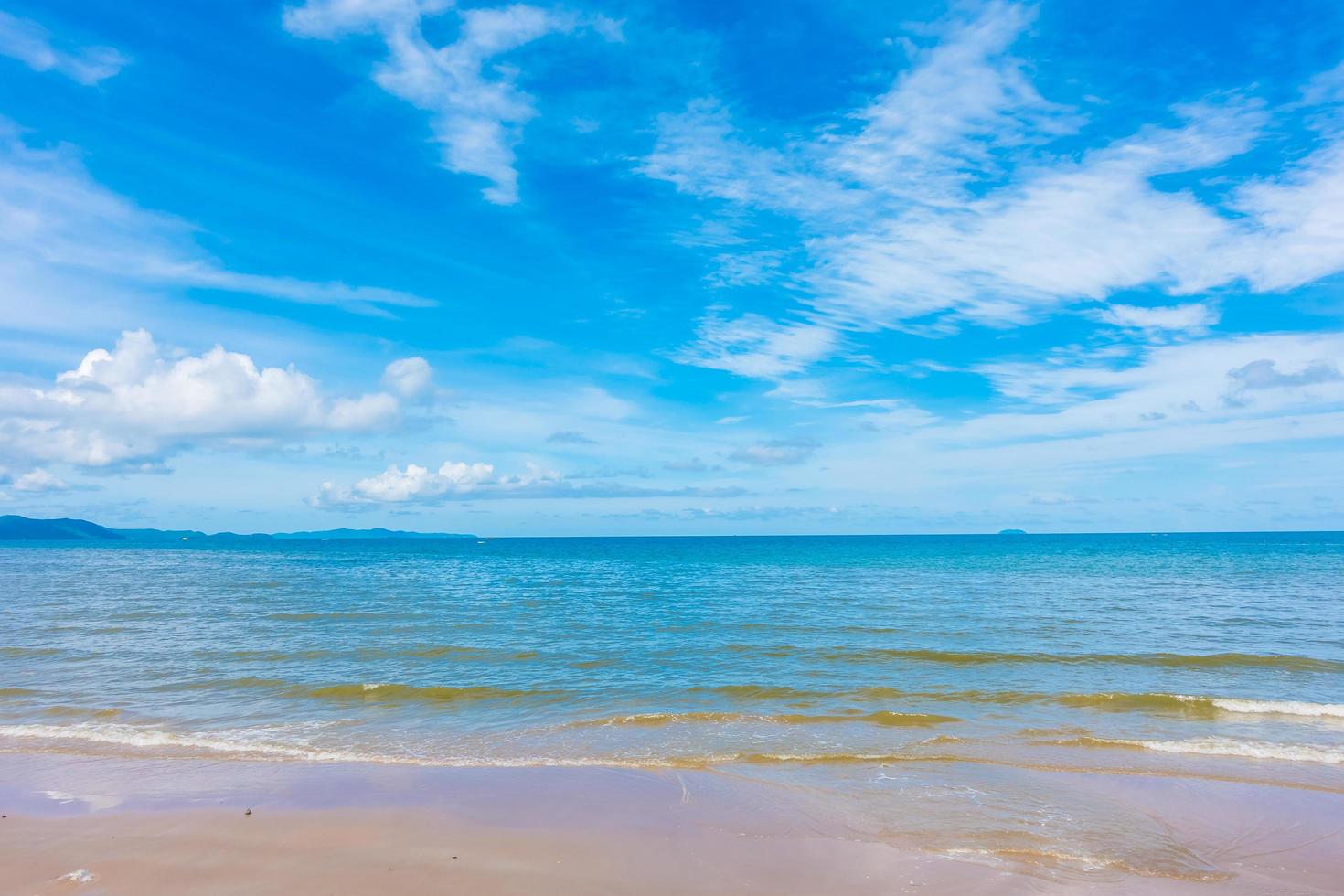 Beautiful beach with sea and ocean on blue sky photo