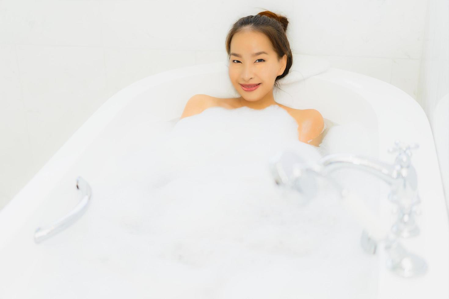 Portrait beautiful young asian woman take a bathtub in bathroom photo