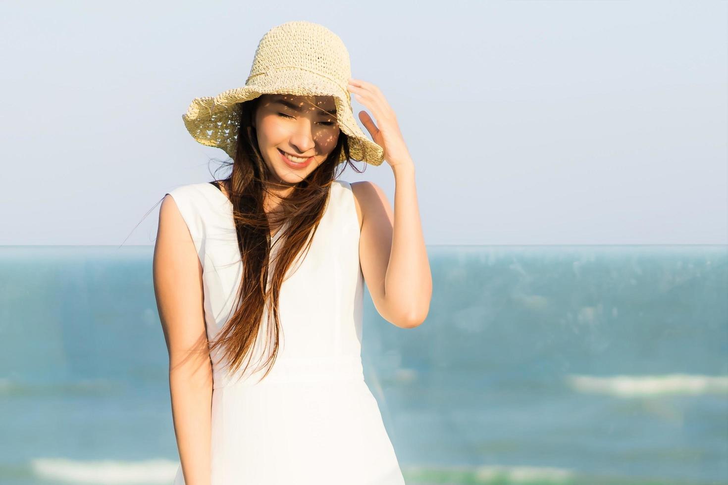 Portrait beautiful young asian woman happy and smile on the beach sea and ocean photo