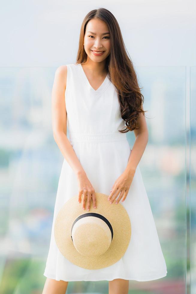 Portrait beautiful young asian woman happy smile relax on the roof top bar photo