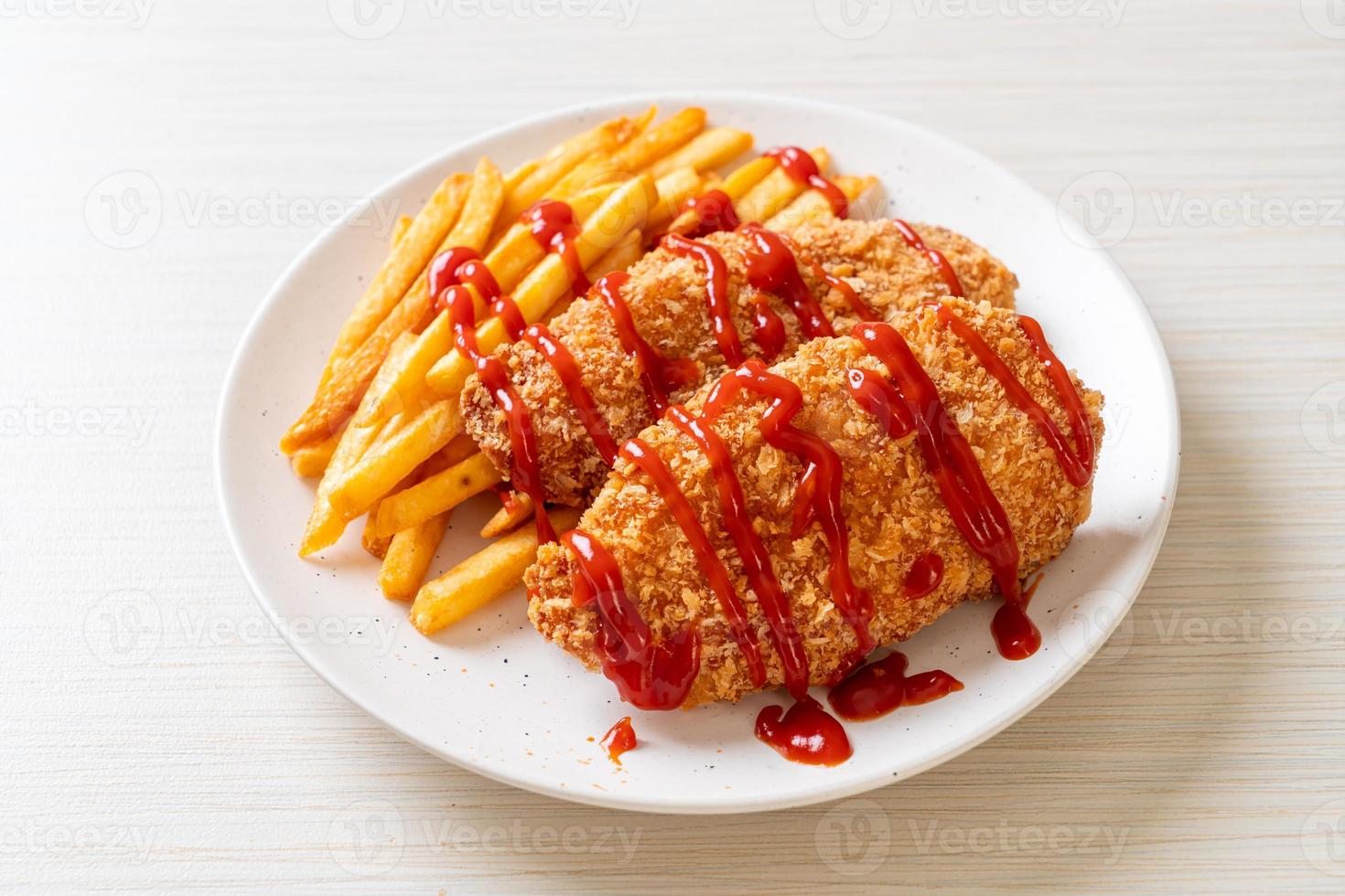 Fried chicken breast fillet steak with French fries and ketchup photo