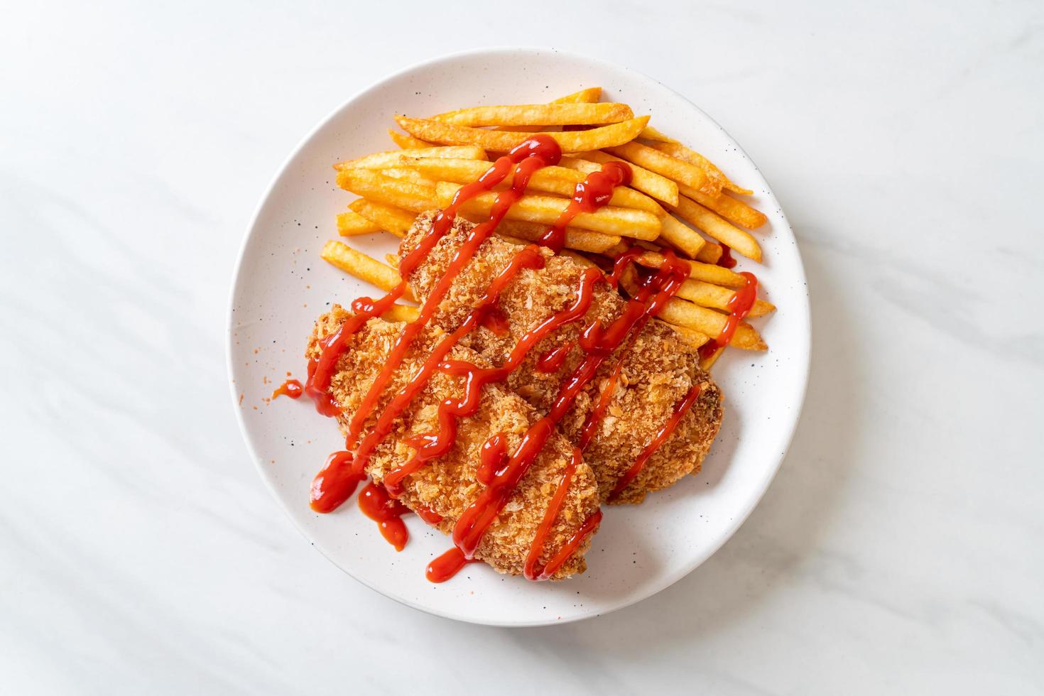 Fried chicken breast fillet steak with French fries and ketchup photo